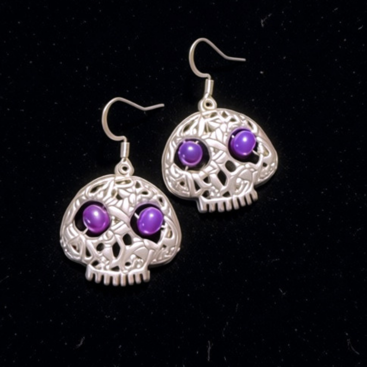 Elegant Silver Filigree Skull Earrings with Purple Pearl Eyes